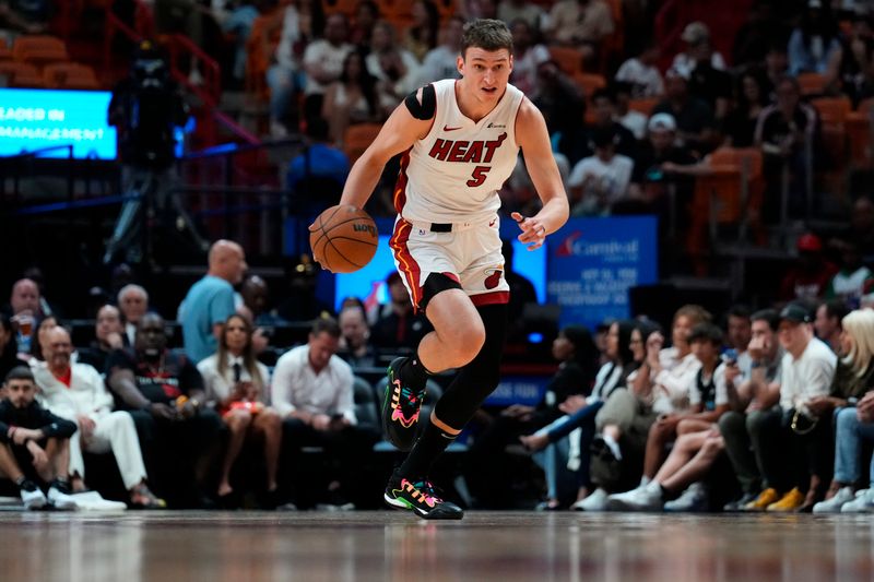 MIAMI, FLORIDA - APRIL 19: Nikola Jovic #5 of the Miami Heat dribbles the ball up the court against the Chicago Bulls in the first quarter during the Play-In Tournament at Kaseya Center on April 19, 2024 in Miami, Florida. NOTE TO USER: User expressly acknowledges and agrees that, by downloading and or using this photograph, User is consenting to the terms and conditions of the Getty Images License Agreement. (Photo by Rich Storry/Getty Images)