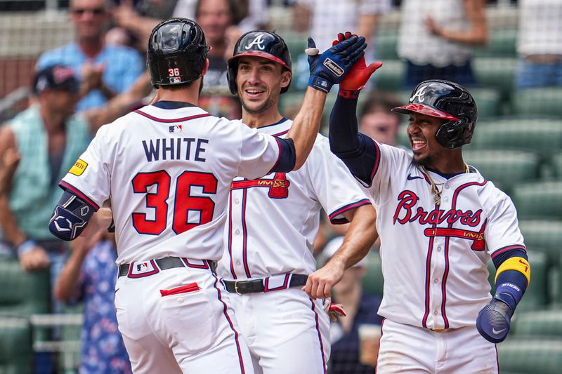 Apr 23, 2025; Cumberland, Georgia, USA; Atlanta Braves outfielder Eli White (36) reacts with first base Matt Olson (28) and second base Ozzie Albies (1) after hitting a three run home run against the St. Louis Cardinals during the eighth inning at Truist Park. Mandatory Credit: Dale Zanine-Imagn Images