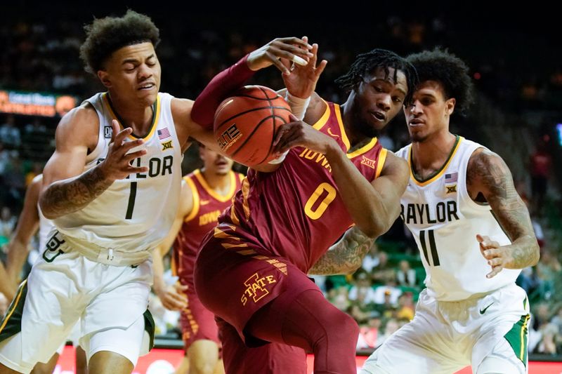Mar 4, 2023; Waco, Texas, USA; Baylor Bears guard Keyonte George (1) and Iowa State Cyclones forward Tre King (0) battle for the ball during the first half at Ferrell Center. Mandatory Credit: Raymond Carlin III-USA TODAY Sports