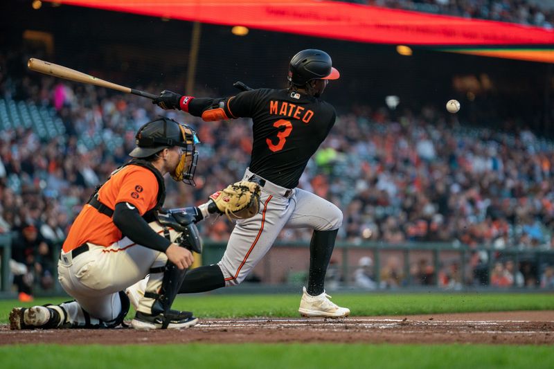 Jun 2, 2023; San Francisco, California, USA;  Baltimore Orioles shortstop Jorge Mateo (3) hits a RBI single to San Francisco Giants catcher Patrick Bailey (14) during the second inning at Oracle Park. Mandatory Credit: Neville E. Guard-USA TODAY Sports