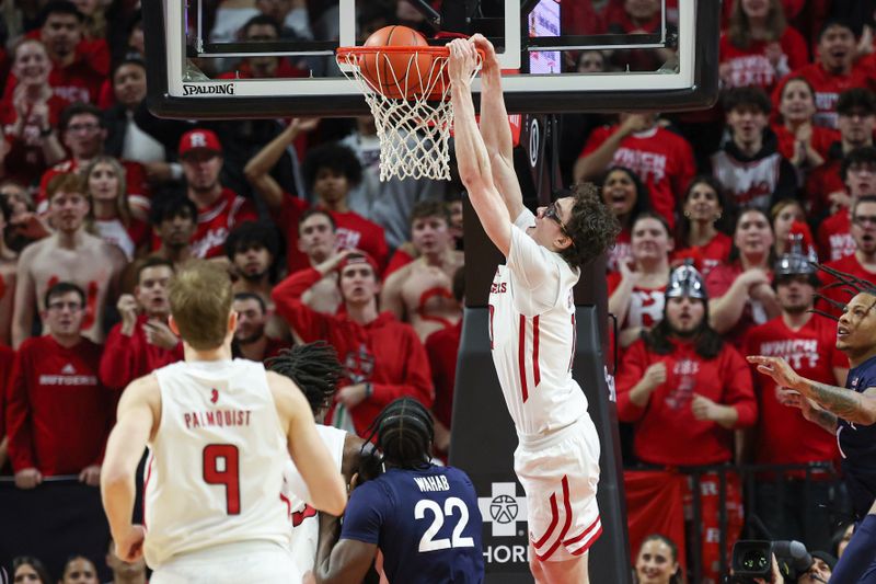 Jan 31, 2024; Piscataway, New Jersey, USA; Rutgers Scarlet Knights guard Gavin Griffiths (10) dunks the ball during the first half in front of Penn State Nittany Lions forward Qudus Wahab (22) at Jersey Mike's Arena. Mandatory Credit: Vincent Carchietta-USA TODAY Sports