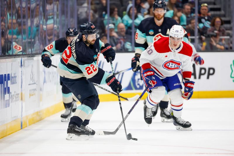 Mar 24, 2024; Seattle, Washington, USA; Seattle Kraken right wing Oliver Bjorkstrand (22) passes the puck against the Montreal Canadiens during the first period at Climate Pledge Arena. Mandatory Credit: Joe Nicholson-USA TODAY Sports