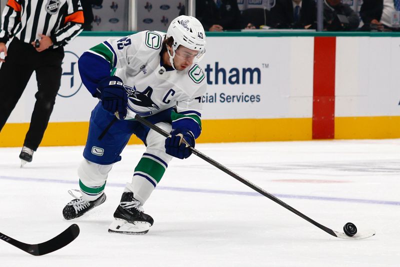 Oct 16, 2025; Dallas, Texas, USA; Vancouver Canucks defenseman Quinn Hughes (43) in action against the Dallas Stars during the first period at American Airlines Center. Mandatory Credit: Chris Jones-Imagn Images