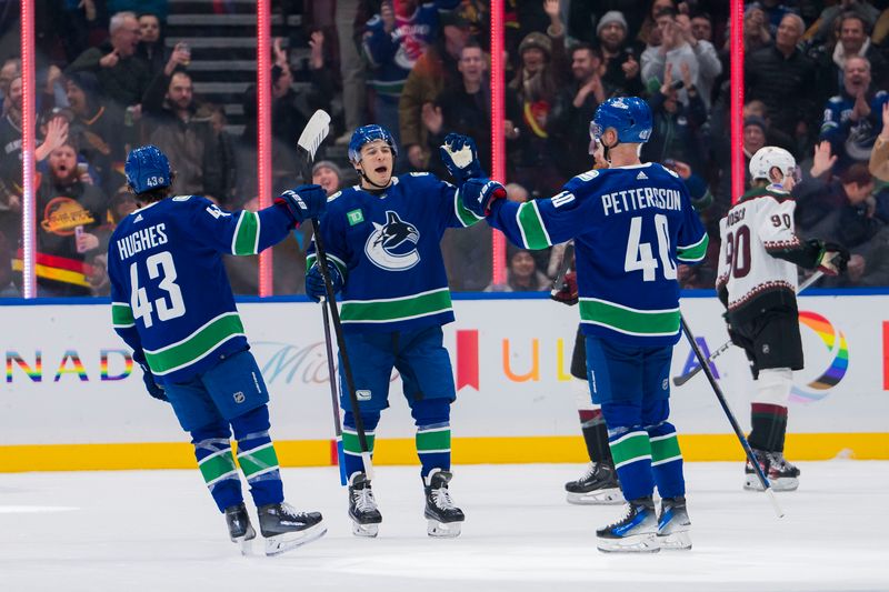 Jan 18, 2024; Vancouver, British Columbia, CAN; Vancouver Canucks defenseman Quinn Hughes (43) and forward Andrei Kuzmenko (96) and forward Elias Pettersson (40) celebrate Pettersson   s goal against the Arizona Coyotes in the first period at Rogers Arena. Mandatory Credit: Bob Frid-USA TODAY Sports