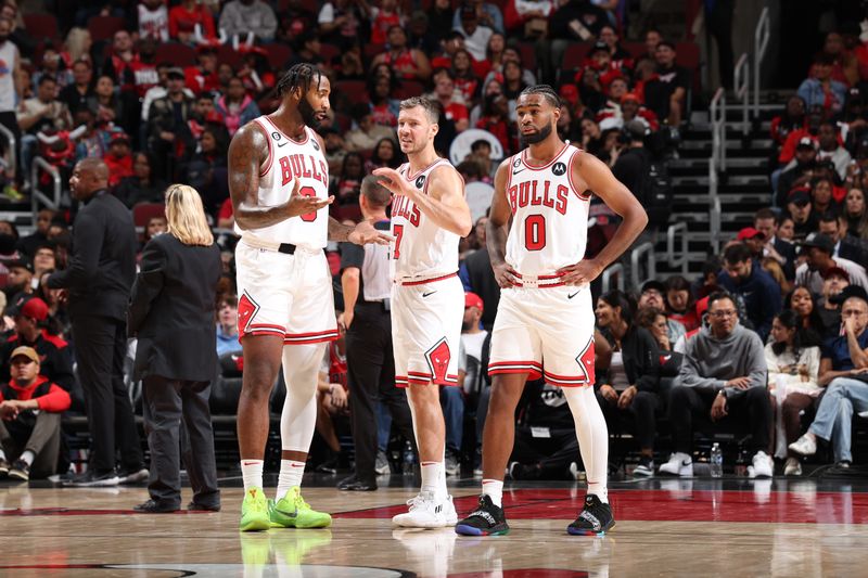 CHICAGO, IL - OCTOBER 4: Andre Drummond #3, Goran Dragic #7 and Coby White #0 of the Chicago Bulls talk during the game against the New Orleans Pelicans on October 4, 2022 at United Center in Chicago, Illinois. NOTE TO USER: User expressly acknowledges and agrees that, by downloading and or using this photograph, User is consenting to the terms and conditions of the Getty Images License Agreement. Mandatory Copyright Notice: Copyright 2022 NBAE (Photo by Jeff Haynes/NBAE via Getty Images)