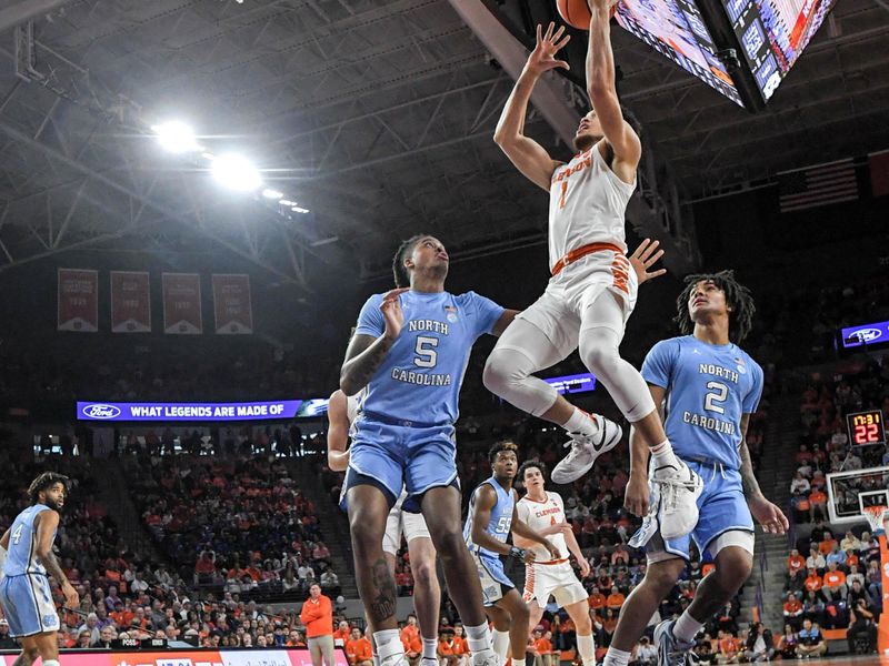 Jan 6, 2024; Clemson, South Carolina, USA; Clemson senior guard Chase Hunter (1) shoots pressured by University of North Carolina center Armando Bacot (5) during the first half at Littlejohn Coliseum. Mandatory Credit: Ken Ruinard-USA TODAY Sports