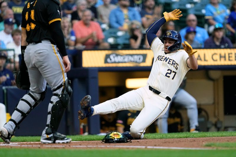 Jul 10, 2024; Milwaukee, Wisconsin, USA;  Milwaukee Brewers shortstop Willy Adames (27) slides into home plate to score a run during the first inning against the Pittsburgh Pirates at American Family Field. Mandatory Credit: Jeff Hanisch-USA TODAY Sports