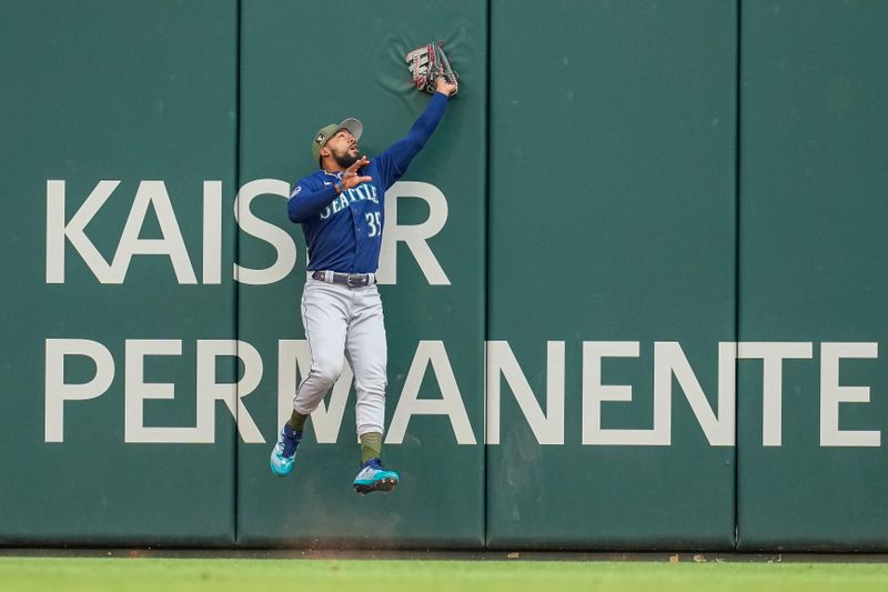 May 19, 2023; Cumberland, Georgia, USA; Seattle Mariners right fielder Teoscar Hernandez (35) catches a ball hit by Atlanta Braves left fielder Eddie Rosario (8) (not shown) at the wall during the first inning at Truist Park. Mandatory Credit: Dale Zanine-USA TODAY Sports