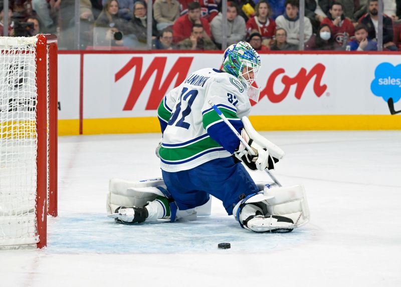 Jan 6, 2025; Montreal, Quebec, CAN; Vancouver Canucks goalie Kevin Lankinen (32) makes a pad save against the Montreal Canadiens during the second period at the Bell Centre. Mandatory Credit: Eric Bolte-Imagn Images