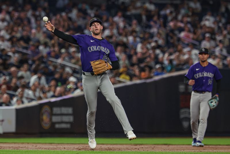 Aug 23, 2024; Bronx, New York, USA; Colorado Rockies third baseman Ryan McMahon (24) throws the ball to first base for an out during the sixth inning against the New York Yankees at Yankee Stadium. Mandatory Credit: Vincent Carchietta-USA TODAY Sports