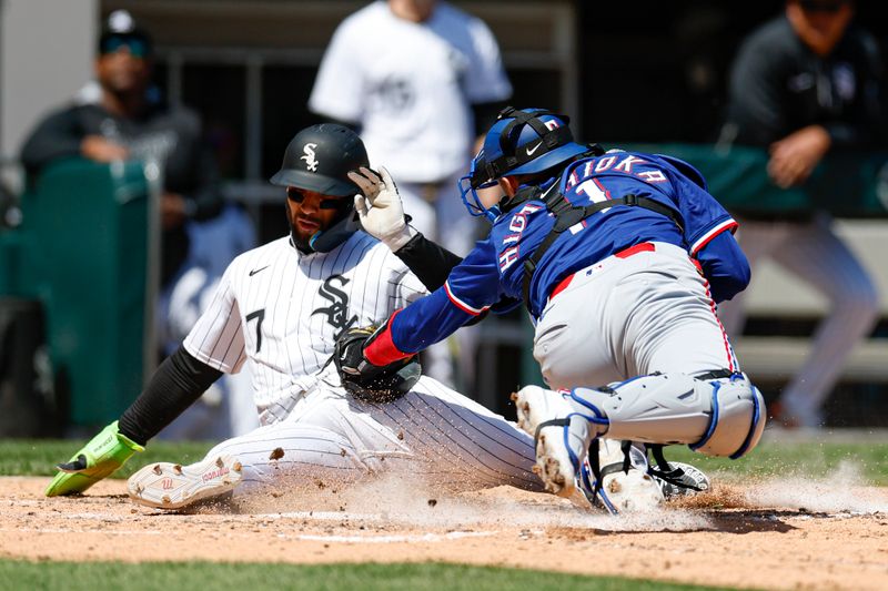 May 25, 2025; Chicago, Illinois, USA; Texas Rangers catcher Kyle Higashioka (11) tags out at home plate Chicago White Sox catcher Edgar Quero (7) during the fifth inning at Rate Field. Mandatory Credit: Kamil Krzaczynski-Imagn Images