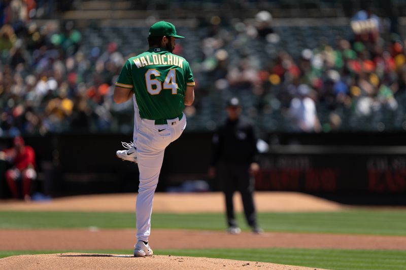 Apr 30, 2023; Oakland, California, USA;  Oakland Athletics starting pitcher Ken Waldichuk (64) pitches during the first inning against the Cincinnati Reds at RingCentral Coliseum. Mandatory Credit: Stan Szeto-USA TODAY Sports