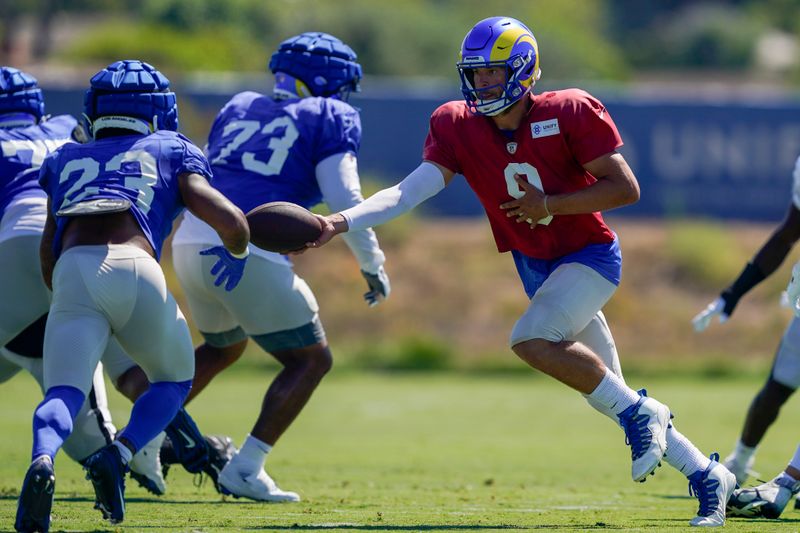 Los Angeles Rams quarterback Matthew Stafford (9) hands off the ball to running back Kyren Williams (23) during a joint NFL football practice with the Las Vegas Raiders, Wednesday, Aug. 16, 2023, in Thousand Oaks, Calif. (AP Photo/Ryan Sun)