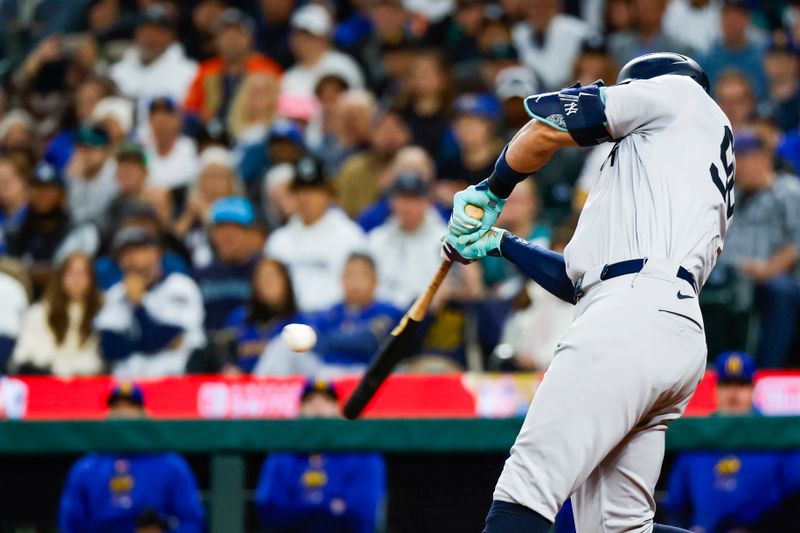 Sep 17, 2024; Seattle, Washington, USA; New York Yankees designated hitter Aaron Judge (99) hits a tow-run single against the Seattle Mariners during the second inning at T-Mobile Park. Mandatory Credit: Joe Nicholson-Imagn Images