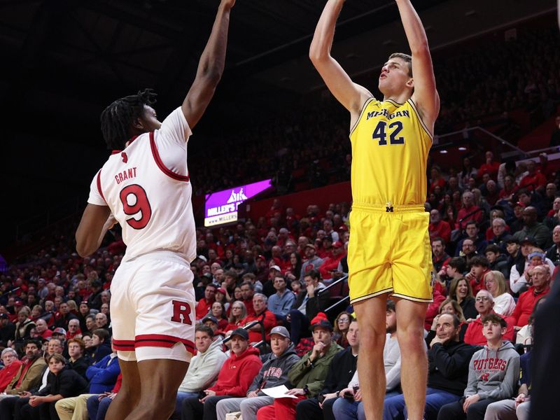 Feb 1, 2025; Piscataway, New Jersey, USA; Michigan Wolverines forward Will Tschetter (42) shoots the ball as Rutgers Scarlet Knights forward Dylan Grant (9) defends during the first half at Jersey Mike's Arena. Mandatory Credit: Vincent Carchietta-Imagn Images