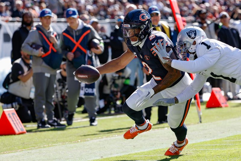 Chicago Bears wide receiver DJ Moore, left, is stopped short of the goal line by Las Vegas Raiders safety Marcus Epps, right, during the first half of an NFL football game, Sunday, Oct. 22, 2023, in Chicago. (AP Photo/Kamil Krzaczynski)