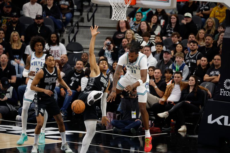 SAN ANTONIO, TX - JANUARY 27: Keldon Johnson #3 of the San Antonio Spurs fights for a rebound with Naz Reid #11 of the Minnesota Timberwolves in the first half at Frost Bank Center on January 27, 2024 in San Antonio, Texas. NOTE TO USER: User expressly acknowledges and agrees that, by downloading and or using this photograph, User is consenting to terms and conditions of the Getty Images License Agreement. (Photo by Ronald Cortes/Getty Images)