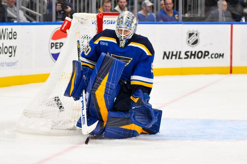 Nov 12, 2024; St. Louis, Missouri, USA;  St. Louis Blues goaltender Jordan Binnington (50) defends the net against the Boston Bruins during the first period at Enterprise Center. Mandatory Credit: Jeff Curry-Imagn Images