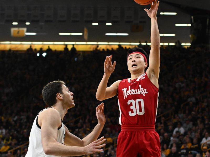 Mar 5, 2023; Iowa City, Iowa, USA; Nebraska Cornhuskers guard Keisei Tominaga (30) shoots the ball over Iowa Hawkeyes forward Filip Rebraca (0) during the first half at Carver-Hawkeye Arena. Mandatory Credit: Jeffrey Becker-USA TODAY Sports