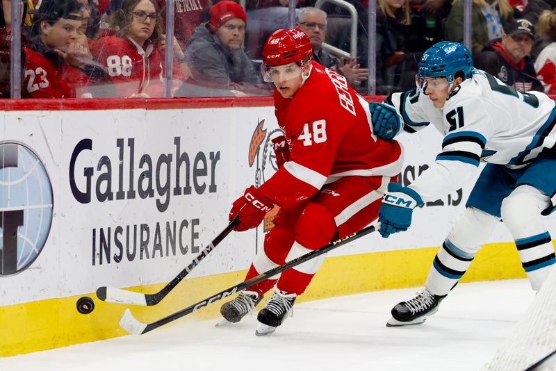 Jan 14, 2025; Detroit, Michigan, USA;  Detroit Red Wings right wing Jonatan Berggren (48) and San Jose Sharks right wing Collin Graf (51) battle for the puck in the second period at Little Caesars Arena. Mandatory Credit: Rick Osentoski-Imagn Images