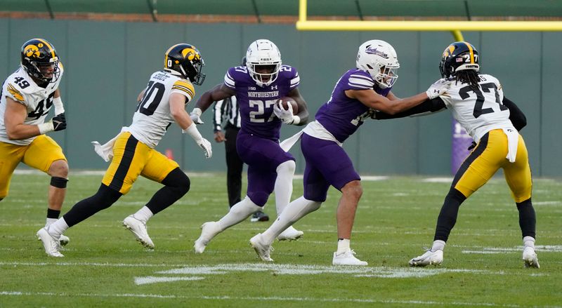 Nov 4, 2023; Chicago, Illinois, USA; Northwestern Wildcats running back Anthony Tyus III runs against the Iowa Hawkeyes during the second half at Wrigley Field. Mandatory Credit: David Banks-USA TODAY Sports