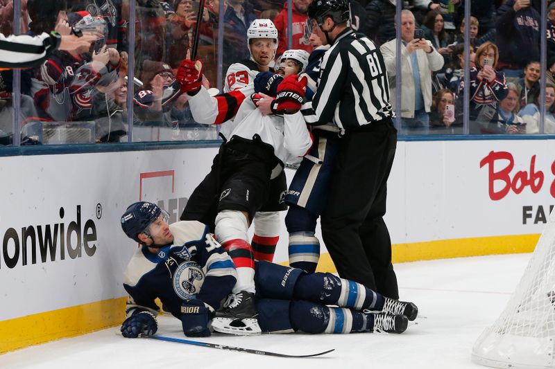 Dec 31, 2025; Columbus, Ohio, USA; New Jersey Devils defenseman Jonas Siegenthaler (71) falls on top of Columbus Blue Jackets center Boone Jenner (38) as Charlie Coyle (3) pulls him away during the second period at Nationwide Arena. Mandatory Credit: Russell LaBounty-Imagn Images