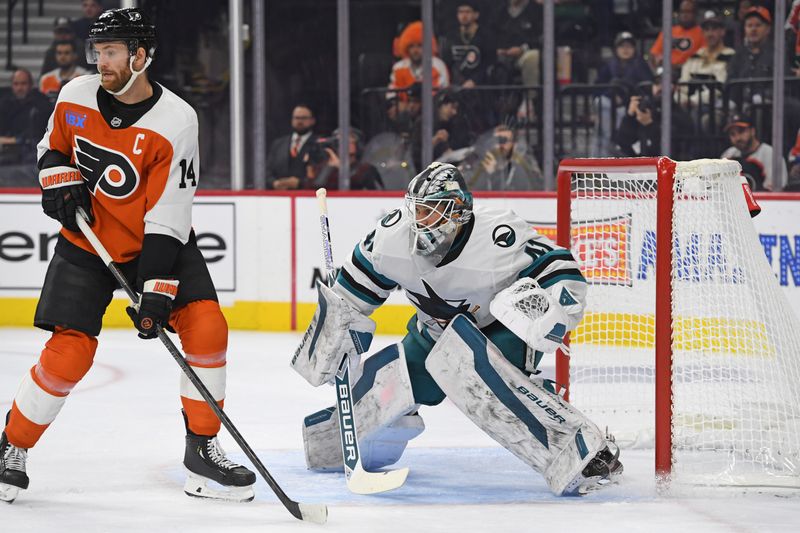 Nov 11, 2024; Philadelphia, Pennsylvania, USA; Philadelphia Flyers center Sean Couturier (14) stands in front of San Jose Sharks goaltender Vitek Vanecek (41) during the first period at Wells Fargo Center. Mandatory Credit: Eric Hartline-Imagn Images