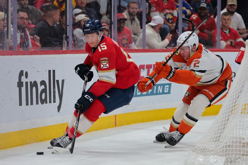 Jan 18, 2025; Sunrise, Florida, USA; Florida Panthers center Anton Lundell (15) moves the puck past Anaheim Ducks defenseman Jackson LaCombe (2) during the first period at Amerant Bank Arena. Mandatory Credit: Sam Navarro-Imagn Images