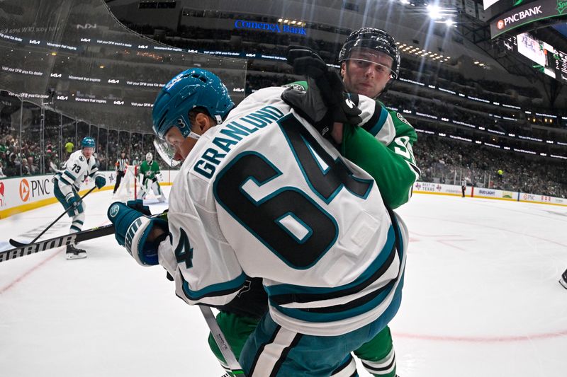 Oct 15, 2024; Dallas, Texas, USA; Dallas Stars defenseman Thomas Harley (55) checks San Jose Sharks center Mikael Granlund (64) during the first period at the American Airlines Center. Mandatory Credit: Jerome Miron-Imagn Images