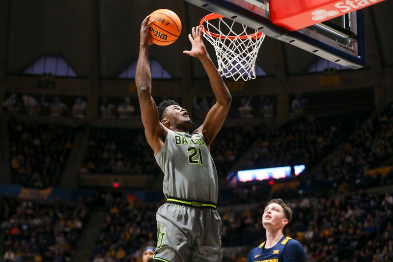 Feb 17, 2024; Morgantown, West Virginia, USA; Baylor Bears center Yves Missi (21) shoots in the lane during the first half against the West Virginia Mountaineers at WVU Coliseum. Mandatory Credit: Ben Queen-USA TODAY Sports