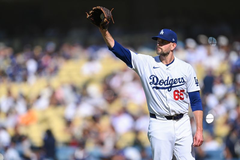Jul 21, 2024; Los Angeles, California, USA; Los Angeles Dodgers pitcher James Paxton (65) at the mount against the Boston Red Sox during the first inning at Dodger Stadium. Mandatory Credit: Jonathan Hui-USA TODAY Sports