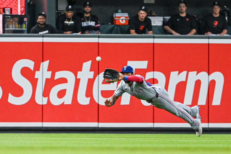 Jun 29, 2024; Baltimore, Maryland, USA;  Texas Rangers outfielder Derek Hill (40) divers a for a first inning fly ball against the Baltimore Orioles at Oriole Park at Camden Yards. Mandatory Credit: Tommy Gilligan-USA TODAY Sports