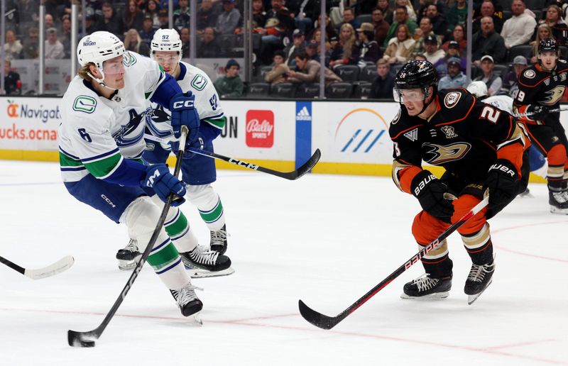 Mar 3, 2024; Anaheim, California, USA; Vancouver Canucks right wing Brock Boeser (6) shoots against Anaheim Ducks defenseman Gustav Lindstrom (28) during the first period at Honda Center. Mandatory Credit: Jason Parkhurst-USA TODAY Sports