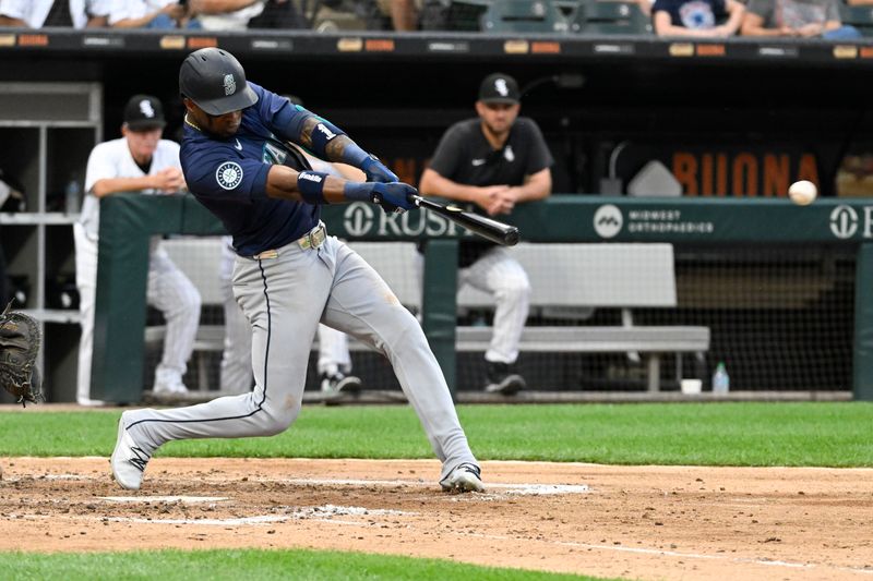 Jul 27, 2024; Chicago, Illinois, USA;  Seattle Mariners outfielder Victor Robles (10) hits an RBI single against the Chicago White Sox during the fourth inning at Guaranteed Rate Field. Mandatory Credit: Matt Marton-USA TODAY Sports