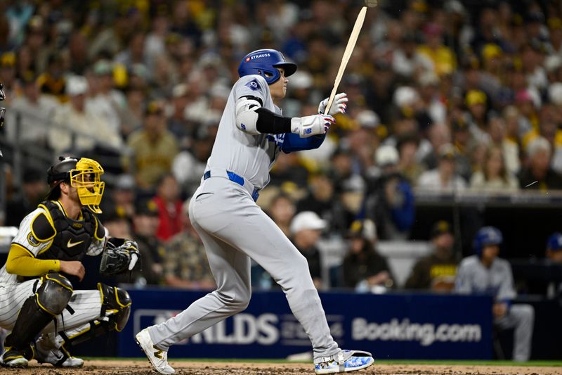 Oct 8, 2024; San Diego, California, USA; Los Angeles Dodgers designated hitter Shohei Ohtani (17) hits a single in the third inning against the San Diego Padres during game three of the NLDS for the 2024 MLB Playoffs at Petco Park.  Mandatory Credit: Denis Poroy-Imagn Images