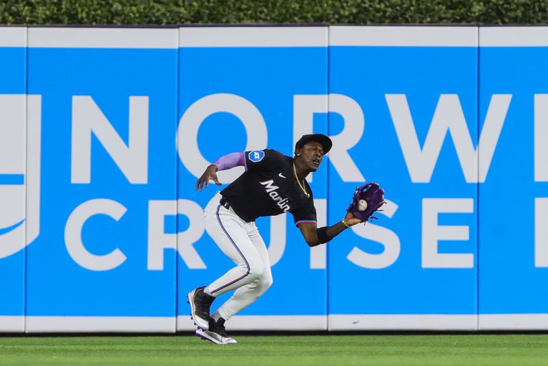 Jun 21, 2024; Miami, Florida, USA; Miami Marlins center fielder Jazz Chisholm Jr. (2) catches the baseball to retire Seattle Mariners first baseman Ty France (not pictured) during the fourth inning at loanDepot Park. Mandatory Credit: Sam Navarro-USA TODAY Sports