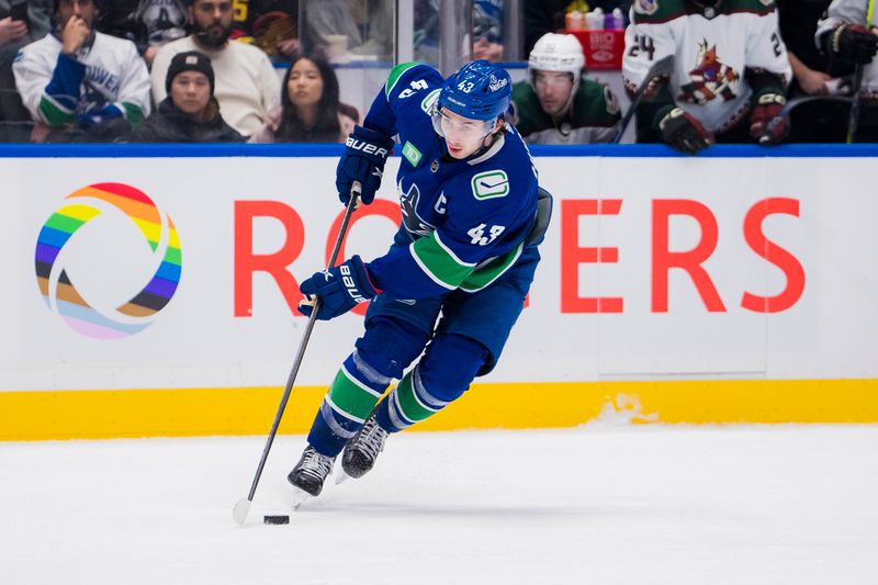 Jan 18, 2024; Vancouver, British Columbia, CAN; Vancouver Canucks defenseman Quinn Hughes (43) handles the puck against the Arizona Coyotes in the third period at Rogers Arena. Vancouver won 2-1. Mandatory Credit: Bob Frid-USA TODAY Sports