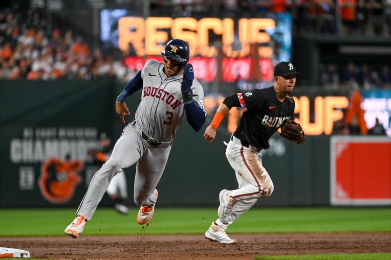 Aug 23, 2024; Baltimore, Maryland, USA;  Houston Astros shortstop Jeremy Pena (3) rounds third base as Baltimore Orioles third baseman Ramon Urias (29) breaks on a infield hit at Oriole Park at Camden Yards. Mandatory Credit: Tommy Gilligan-USA TODAY Sports