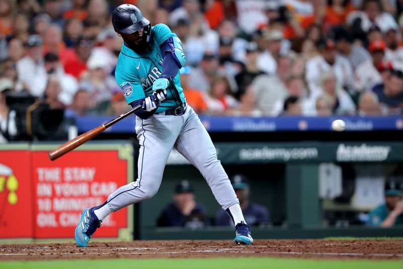 Aug 19, 2023; Houston, Texas, USA; Seattle Mariners designated hitter Teoscar Hernandez (35) hits an RBI double against the Houston Astros during the third inning at Minute Maid Park. Mandatory Credit: Erik Williams-USA TODAY Sports