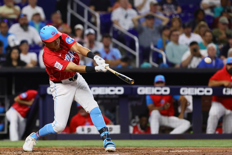 Apr 27, 2024; Miami, Florida, USA; Miami Marlins right fielder Avisail Garcia (24) hits a single against the Washington Nationals during the third inning at loanDepot Park. Mandatory Credit: Sam Navarro-USA TODAY Sports