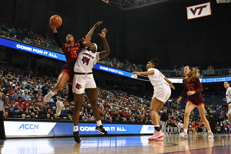 Mar 5, 2023; Greensboro, NC, USA; Virginia Tech Hokies forward Taylor Soule (13) shoots past Louisville Cardinals forward Olivia Cochran (44) during the second half at Greensboro Coliseum. Mandatory Credit: William Howard-USA TODAY Sports