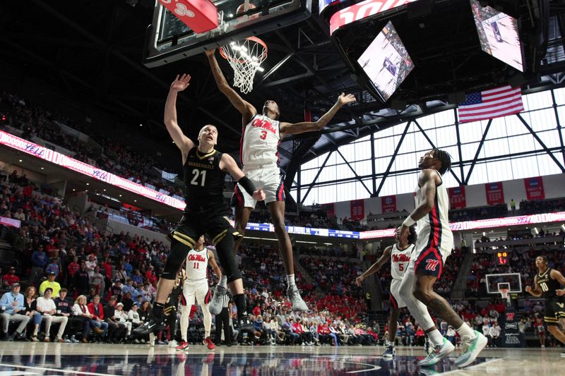 Jan 13, 2024; Oxford, Mississippi, USA; Mississippi Rebels forward Jamarion Sharp (3) blocks a shot attempt by Vanderbilt Commodores forward Tasos Kamateros (21) during the first half at The Sandy and John Black Pavilion at Ole Miss. Mandatory Credit: Petre Thomas-USA TODAY Sports