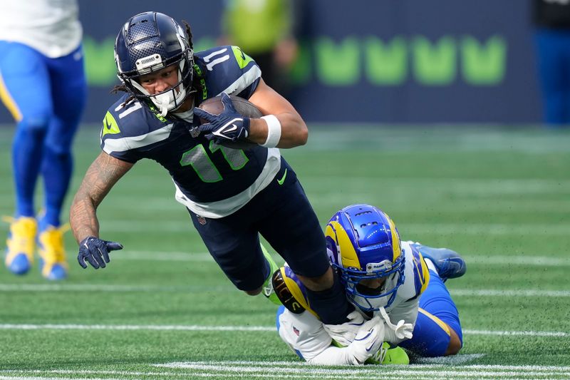 Seattle Seahawks wide receiver Jaxon Smith-Njigba (11) is tackled by Los Angeles Rams cornerback Cobie Durant during the first half of an NFL football game in Seattle, Sunday, Nov. 3, 2024. (AP Photo/Stephen Brashear)