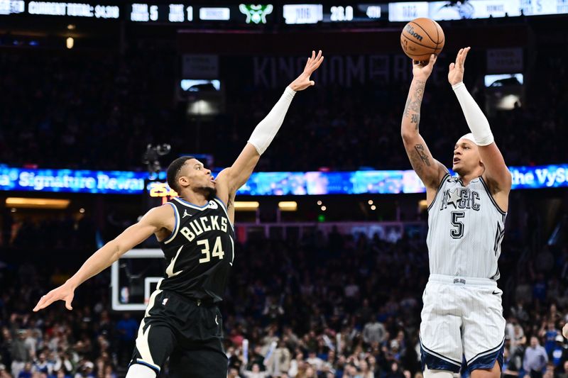 ORLANDO, FLORIDA - JANUARY 10: Paolo Banchero #5 of the Orlando Magic shoots a three-point-basket against Giannis Antetokounmpo #34 of the Milwaukee Bucks in the second half of a game at Kia Center on January 10, 2025 in Orlando, Florida. NOTE TO USER: User expressly acknowledges and agrees that, by downloading and or using this photograph, User is consenting to the terms and conditions of the Getty Images License Agreement. (Photo by Julio Aguilar/Getty Images)