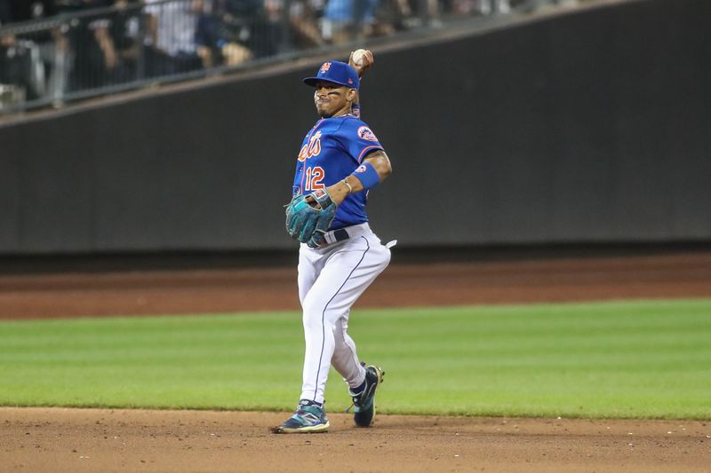 Jul 19, 2023; New York City, New York, USA;  New York Mets shortstop Francisco Lindor (12) throws a runner out at first base in the ninth inning against the Chicago White Sox at Citi Field. Mandatory Credit: Wendell Cruz-USA TODAY Sports