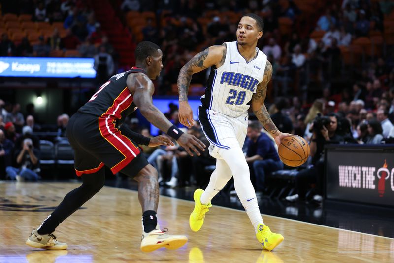 MIAMI, FLORIDA - FEBRUARY 06: Markelle Fultz #20 of the Orlando Magic dribbles the ball against Terry Rozier #2 of the Miami Heat during the first quarter of the game at Kaseya Center on February 06, 2024 in Miami, Florida. NOTE TO USER: User expressly acknowledges and agrees that, by downloading and or using this photograph, User is consenting to the terms and conditions of the Getty Images License Agreement. (Photo by Megan Briggs/Getty Images)