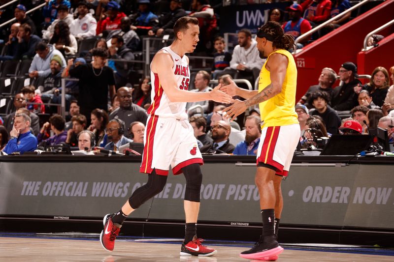 DETROIT, MI - MARCH 15: Duncan Robinson #55 high fives Patty Mills #88 of the Miami Heat during the game against the Detroit Pistons on March 15, 2024 at Little Caesars Arena in Detroit, Michigan. NOTE TO USER: User expressly acknowledges and agrees that, by downloading and/or using this photograph, User is consenting to the terms and conditions of the Getty Images License Agreement. Mandatory Copyright Notice: Copyright 2024 NBAE (Photo by Brian Sevald/NBAE via Getty Images)