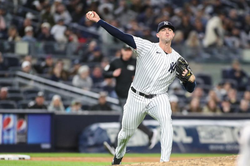 May 1, 2023; Bronx, New York, USA;  New York Yankees relief pitcher Clay Holmes (35) attempts to throw a runner out after making an error in the ninth inning against the Cleveland Guardians at Yankee Stadium. Mandatory Credit: Wendell Cruz-USA TODAY Sports