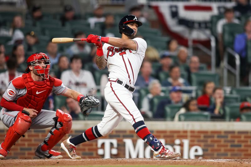 Apr 11, 2023; Atlanta, Georgia, USA; Atlanta Braves left fielder Eddie Rosario (8) hits a single against the Cincinnati Reds in the seventh inning at Truist Park. Mandatory Credit: Brett Davis-USA TODAY Sports
