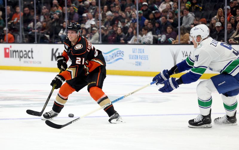 Mar 3, 2024; Anaheim, California, USA; Anaheim Ducks center Isac Lundestrom (21) passes against Vancouver Canucks defenseman Nikita Zadorov (91) during the second period at Honda Center. Mandatory Credit: Jason Parkhurst-USA TODAY Sports